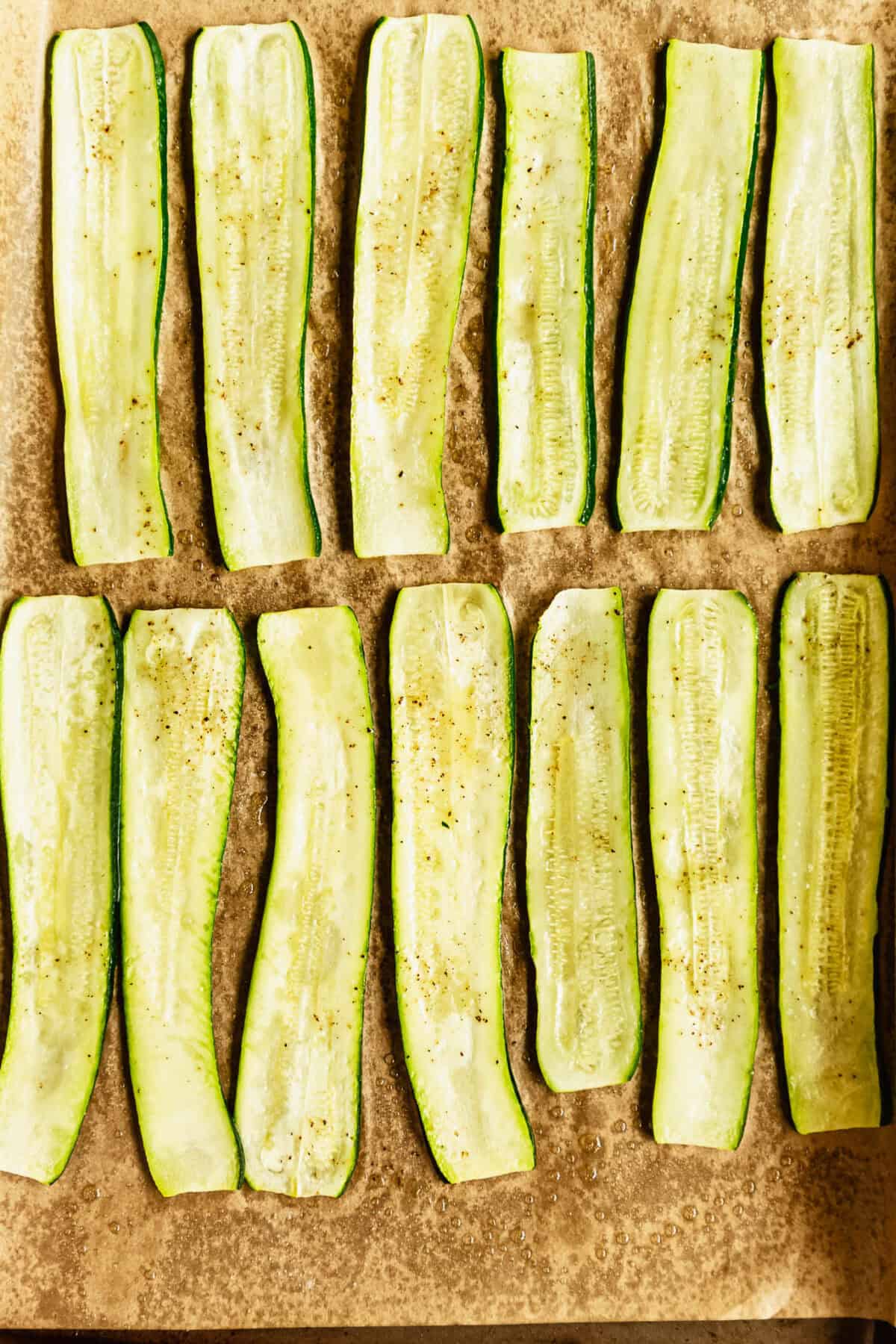 baked sliced zucchini on a baking sheet.