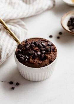 Delicious chocolate chia pudding topped with chocolate chips in a white ramekin.