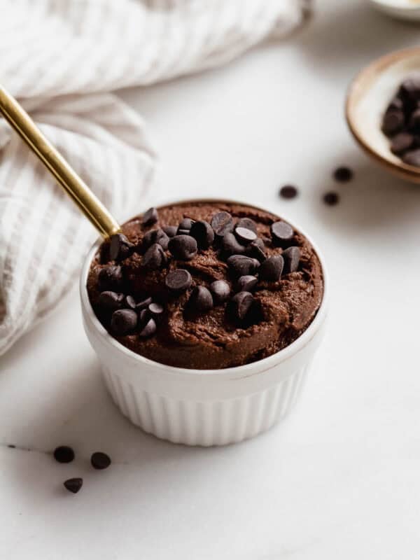 Delicious chocolate chia pudding topped with chocolate chips in a white ramekin.