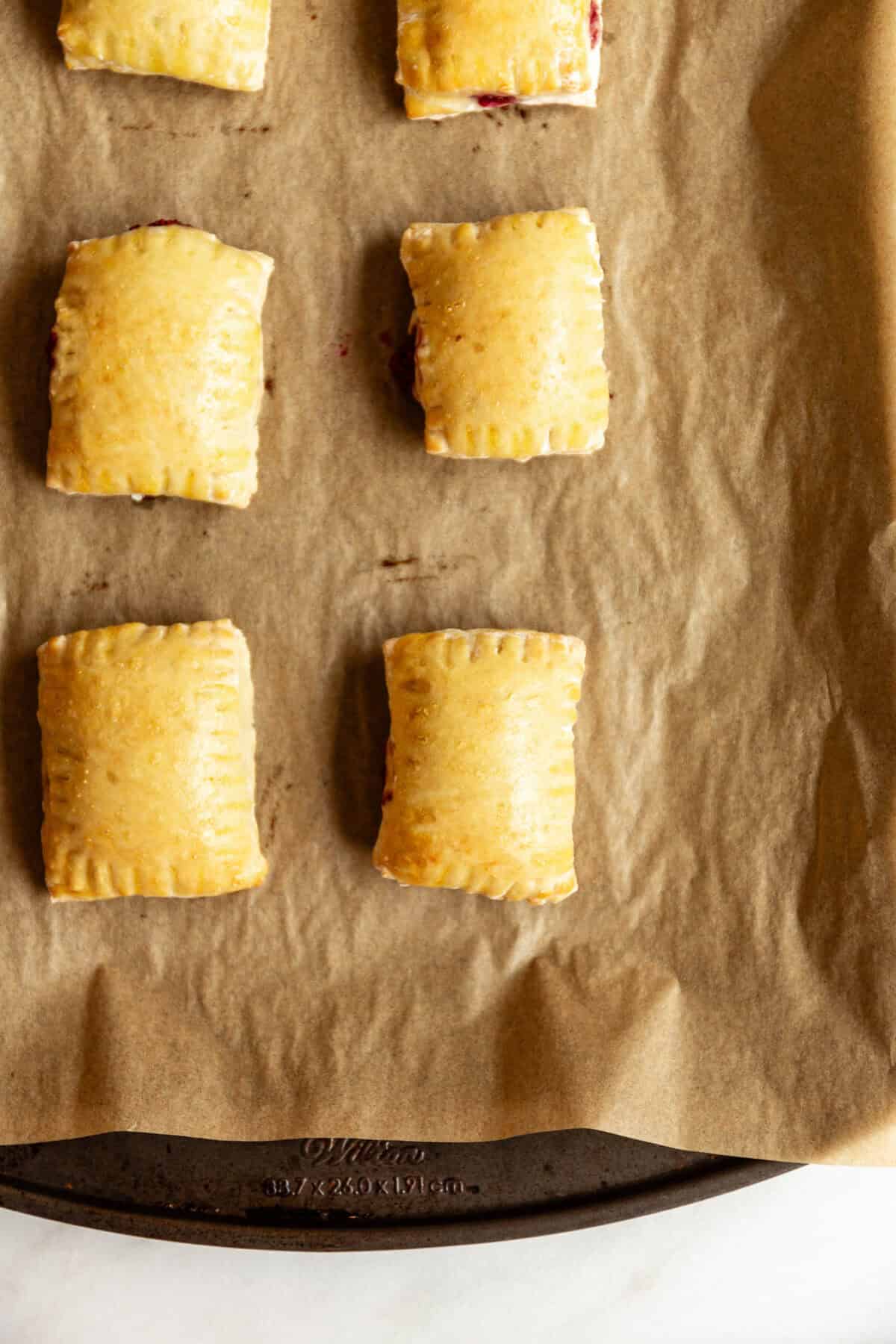 baked Cottage cheese dough pop tarts on a baking sheet.