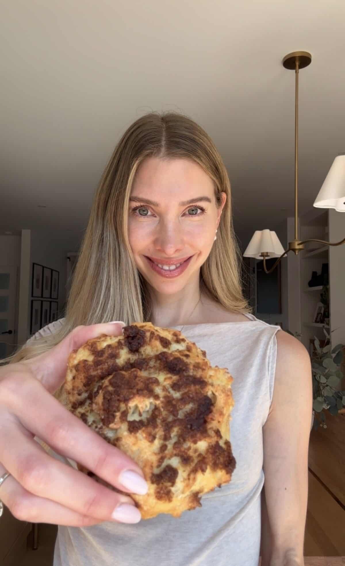 Jess holding a cottage cheese cinnamon crunch biscuit.
