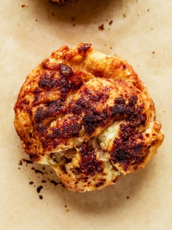 Overhead close-up of a cottage cheese cinnamon crunch biscuit showing its spiral swirl of cinnamon sugar