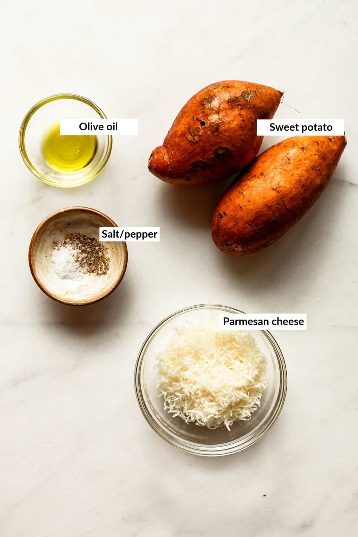 Labeled ingredients for parmesan roasted sweet potatoes, including sweet potato, olive oil, salt and pepper, and parmesan cheese.