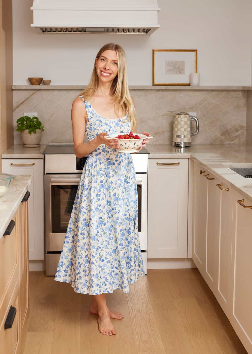 jess carrying strawberries in the kitchen.
