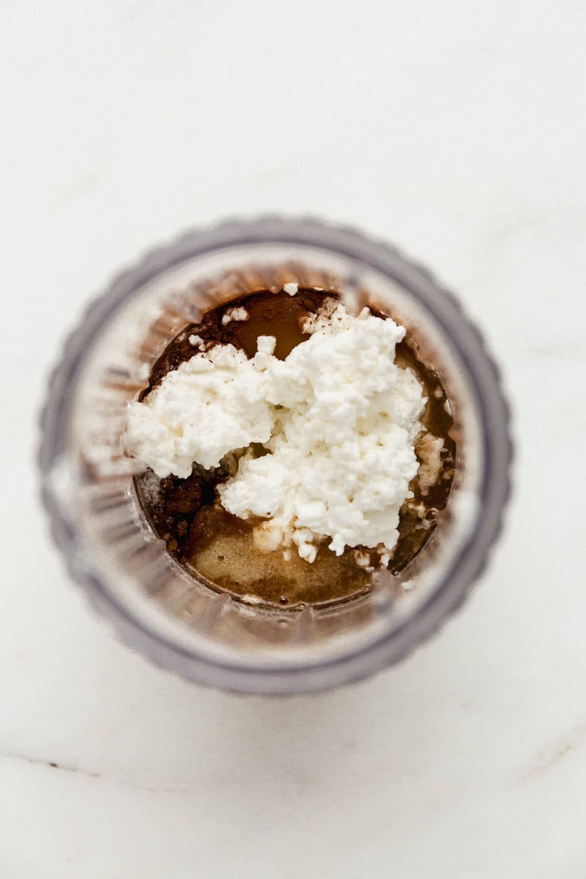 cottage cheese, cocoa powder, egg, flour and maple syrup in a small blender container.